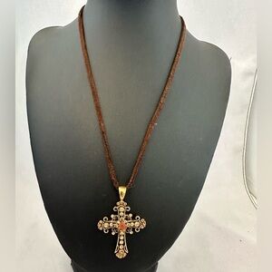 Lia Sophia gold tone cross pendant with orange rhinestones on brown leather cord
